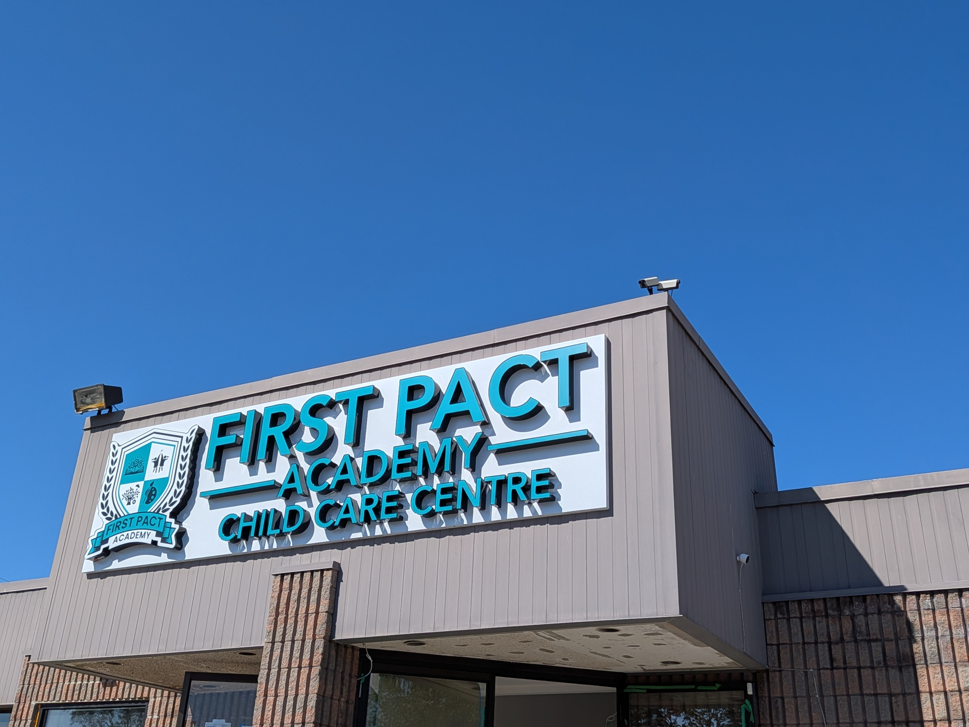 First Pact Academy Child Care Centre exterior signage at 3416 Fairview St in Burlington.